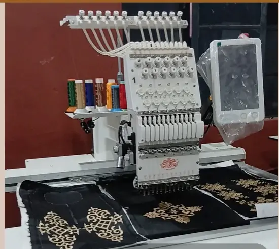 Gold motifs stitched into black twill on the digital embroidery machine