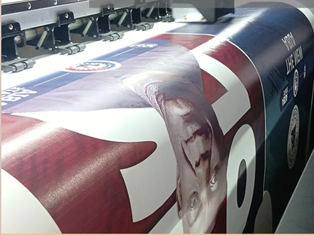 A printed jersey panel coming off the roller of the sublimation printer
